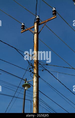 both electrical and optical cable crossed each other, Crowded cables on urban area, Stock Photo