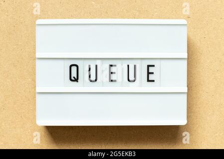 Lightbox with word queue on wood background Stock Photo