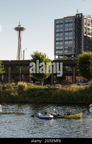 Seattle, USA. 26th Jun, 2021. As sweltering heat envelops Seattle people in row boats pass by in the cool water. The PNW is in the midst of a heat wave that has pushed the Puget sound to historic record three-digit temperatures for the next three days. Credit: James Anderson/Alamy Live News Stock Photo