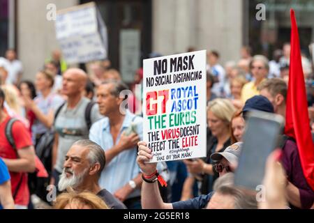 London, UK. 26th June, 2021. A man holds a placard protesting against events such as the G7 summit, Royal Ascot and the Euros going ahead while the rest of the England faces lockdown restrictions during the Freedom March in London. Credit: SOPA Images Limited/Alamy Live News Stock Photo