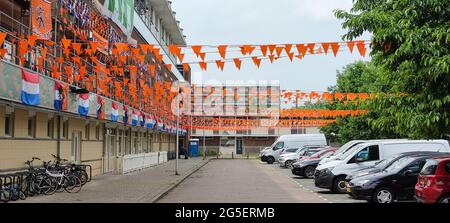 A Dutch street is decorated with flags to support the Dutch national soccer team.