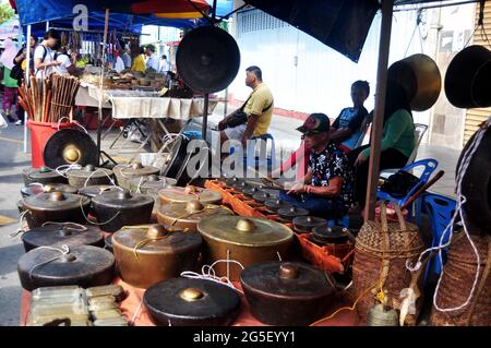 Malays playing gongs traditional music instrument malaysian style for show and sale people traveler on street floor shop at Filipino Market Kota Kinab Stock Photo