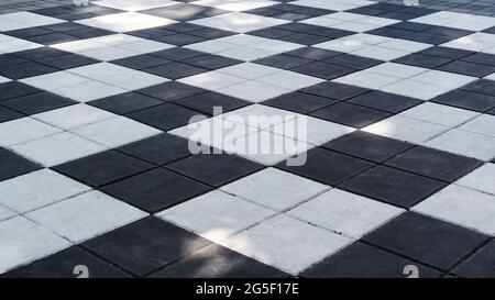 Black and white sidewalk tiles for playing big street chess. Black and white sidewalk tiles for playing street chess. Chess cells drawn on the paving Stock Photo