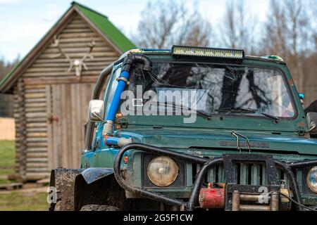 Gulbene, Latvia - May 02, 2021: Compact Japanese SUV Suzuki with off-road tuning in a farmyard, , close-up details Stock Photo