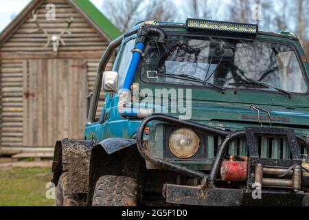 Gulbene, Latvia - May 02, 2021: Compact Japanese SUV Suzuki with off-road tuning in a farmyard, , close-up details Stock Photo