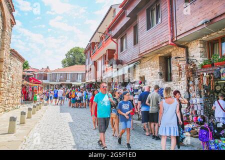 29 of July 2019, Nessebar Bulgaria. Souvenir shops with clothers, magnets and post cards, a lot of people. Stock Photo
