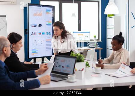 Furious woman screaming at company office boardroom meeting having disagreement controversy. Businesswoman raging about multitasking difficult job, screaming in boardroom Stock Photo