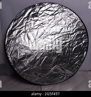 round silver photo reflector with with background Stock Photo