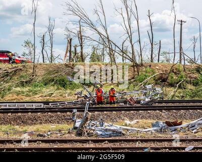 Firemen are seen fixing destroyed railway tracks.Tornado aftermath in Czech Republic, South Moravia region. Tornado of force 4F destroyed several villages on Thursday, June 24th, around 8pm. After one minute of activity left 5 dead and 200 injured and damaged hundreds of houses. This region is facing such a disaster for a first time. Scientists warn that with climate changes, the extreme weather will occurs more often. (Photo by Jana Cavojska / SOPA Images/Sipa USA) Stock Photo