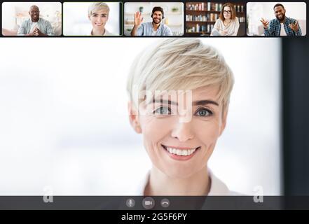 Telecommuting Concept. Smiling businesspeople using videoconference application, engaged in online meeting working distantly from home, computer webca Stock Photo