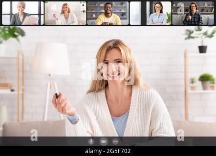 E-learning And Training Concept. Smiling adult men and women making video teleconference on pv, talking with coworkers or students, having remote brie Stock Photo