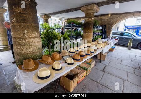 Mens’ hat stall inside Market House, a Cotswold pillared market house in Tetbury, an historic wool town in the Cotswolds, Gloucestershire, SW England Stock Photo