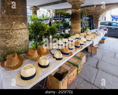 Mens’ hat stall inside Market House, a Cotswold pillared market house in Tetbury, an historic wool town in the Cotswolds, Gloucestershire, SW England Stock Photo