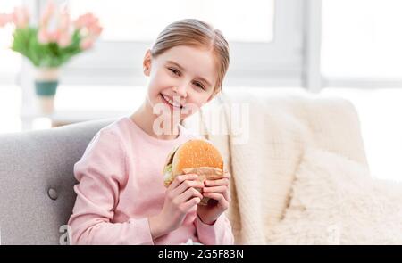 Little girl with hamburger Stock Photo