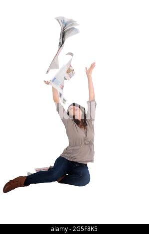 excited and emotional young woman ripping up a printed newspaper studio shot on white background Stock Photo