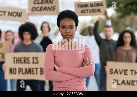 Serious female activist with megaphone in her hand makes loud ...