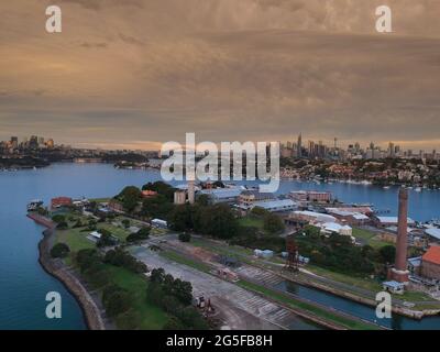 Panorama drone aerial view over Sydney harbour on a cloudy sunset afternoon showing the nice colours of the harbour foreshore Stock Photo