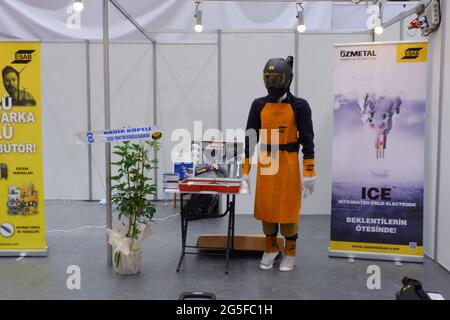 Model dressed with welding protective equipment at exhibition in an industrial fair Stock Photo