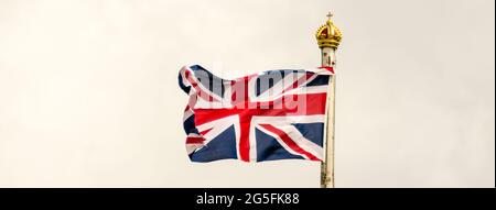 Union Jack Flag flying on a cloudy day in London, UK Stock Photo