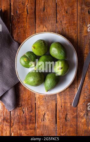 Fresh figs in a plate on a wooden table. Copy space. Stock Photo