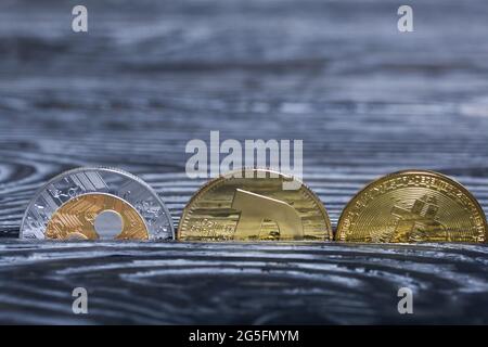 Coins of various cryptocurrencies. On brushed pine boards. Stock Photo