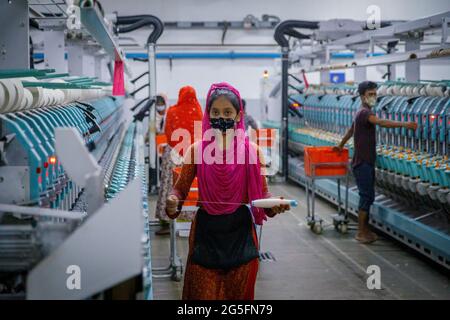 RMG workers at the BEXIMCO plant outside Dhaka in Bangladesh.  In the last seven years, Bangladesh's garment industry has increased its annual revenue from $19 billion to $34 billion—a 79 percent rise. This makes the country the second largest exporter of garments in the world, with the sector accounting for 80 percent of Bangladesh's total export earnings Stock Photo