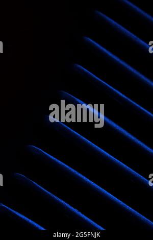 Abstract macro photography. Soft blurred metal texture diagonal line pattern background with blue light Stock Photo