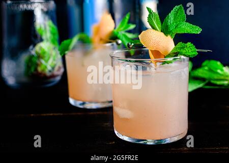 Greek Greyhound Cocktails with Garnish: Refreshing cocktails made with pink grapefruit, vodka, and ouzo served on the rocks Stock Photo