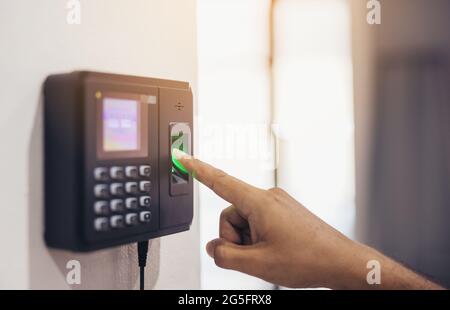 Finger print scan, Male employees press sensors to record company attendance time and after work, Time Recorder Attendance - Out work, Encryption for Stock Photo