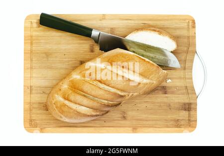 cutting white bread loaf on hardboard and chefs knife Stock Photo