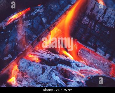 firewood burning in fireplace at blue hour Stock Photo