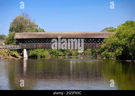 The all wood lattice covered pedestrian & cyclist covered bridge over the Eramosa River built in 1992. Guelph Ontario Canada Stock Photo