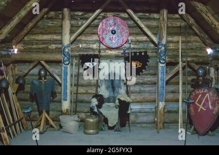 Weapon of the ancient knights sword, axes stand on the background of a wooden wall Stock Photo