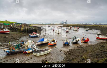 Fishing and pleasure boats in Paddys Hole Harbour, laying on the mud at low tide Teesmouth, Redcar Cleveland UK Stock Photo