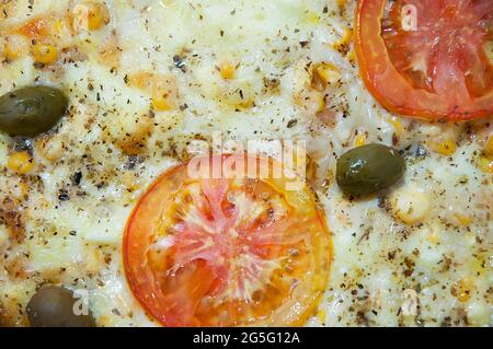 Pizza made at home, the ingredients used were, olives, mozzarella, tomatoes and corn. Stock Photo