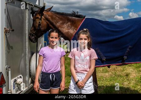 Lissangle, Caheragh, West Cork, Ireland. 27th June, 2021. There was an 8 race card at Lissangle today in the sulky racing on a very warm and sunny day. Enjoying the racing were Grace O'Neill, Skibbereen and Kalya Whooley from Leap. Credit: AG News/Alamy Live News Stock Photo