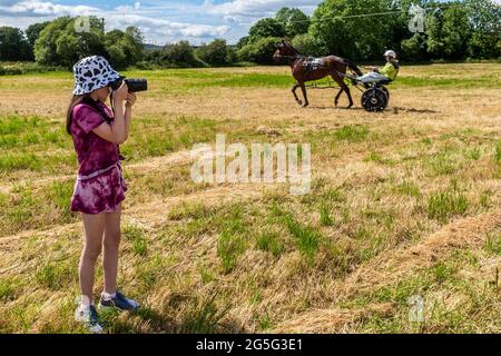 Lissangle, Caheragh, West Cork, Ireland. 27th June, 2021. There was an 8 race card at Lissangle today in the sulky racing on a very warm and sunny day. Lydia Kelleher Shine enjoyed photographing the horses. Credit: AG News/Alamy Live News Stock Photo