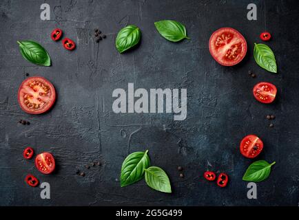 flat lay composition of fresh raw vegetables on painted black background, top view Stock Photo