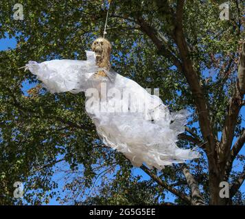 Fabric decorating bow hanging on Christmas tree with copy space in