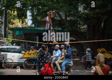 New Delhi, India. 27th June, 2021. An unidentified Indian girl does street acrobatics by walking on a rope in a performance to earn a livelihood. Credit: SOPA Images Limited/Alamy Live News Stock Photo