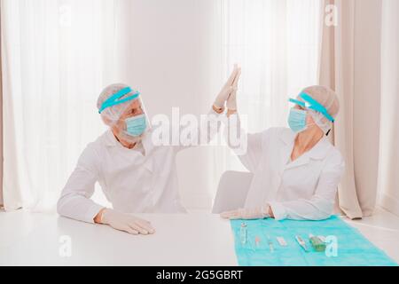 doctors with mask and face protector are ready to work in hospital Stock Photo