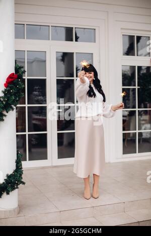 Attractive dark-haired woman with sparklers. Stock Photo