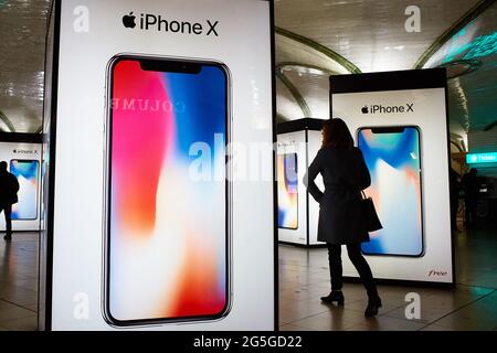 Paris, France, November 2017: french woman walking between electronic advertising panels at the subway station of Gare Saint Lazard Station. The adver Stock Photo