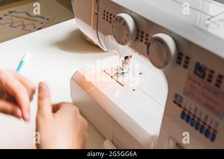 A woman hands using sewing machine Stock Photo