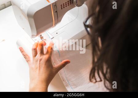A woman hands using sewing machine Stock Photo
