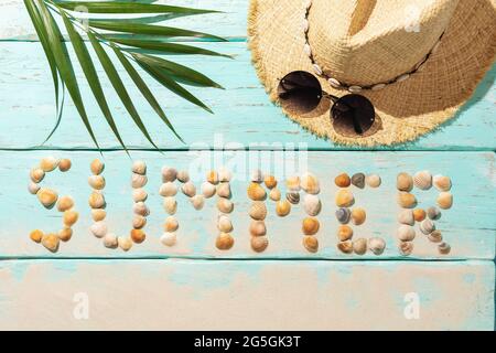 The inscription from seashells on a wooden background, hat and sunglasses, summer background Stock Photo