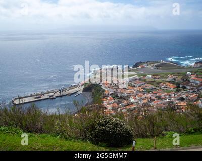 View from above to Vila do Corvo with Flores Island in the horizon across the canal Stock Photo