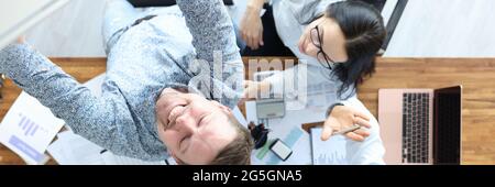 Group of people taking selfie photo on smartphone in office top view Stock Photo
