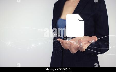 Document Management System Business concept. Hand hold digital hologram business documents on grey background. Corporate data management system DMS. Stock Photo