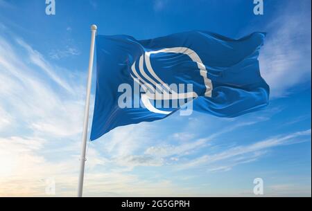 Minsk, Belarus - May, 2021: Flag of Nordic Council waving in the wind at flagpole on background of blue sky. 3d illustration. Stock Photo